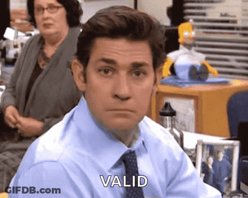 A Man In A Blue Shirt And Tie Is Sitting At A Desk And Says Valid . GIF
