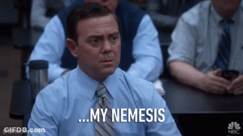 A Man In A Blue Shirt And Tie Is Sitting In A Classroom And Says " My Nemesis " GIF