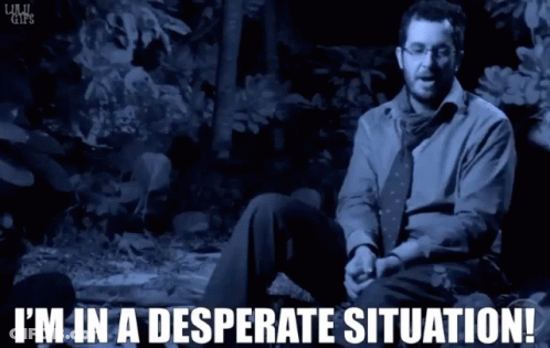 A Man In A Blue Shirt And Tie Is Sitting In A Desperate Situation GIF