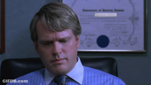 Man In Blue Shirt And Tie In Front Of Certificate GIF