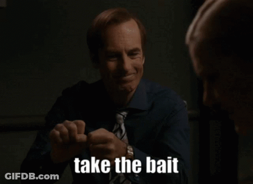 A Man In A Blue Shirt And Tie Is Smiling And Saying Take The Bait GIF