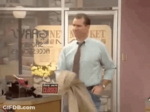 Man In Blue Shirt And Tie In Front Of Closed Store GIF