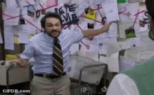 A Man In A Blue Shirt And Tie Is Standing In Front Of A Wall With Papers On It . GIF