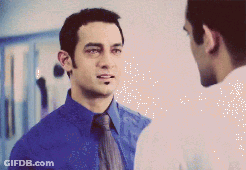 A Man In A Blue Shirt And Tie Is Talking To Another Man GIF