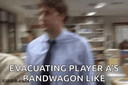 A Man In A Blue Shirt And Tie Is Walking In An Office And Says Evacuating Player A 'S Bandwagon Like GIF