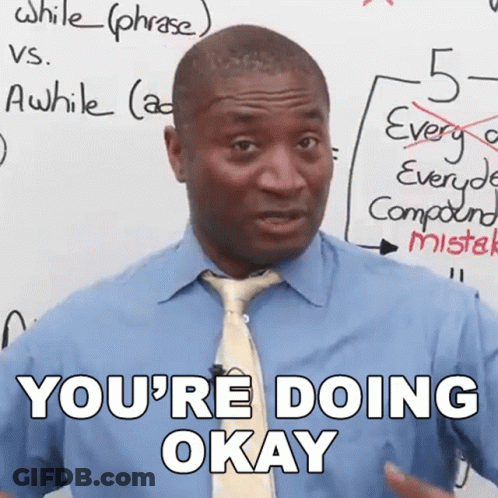 A Man In A Blue Shirt And Tie Says " You 'Re Doing Okay " In Front Of A White Board GIF