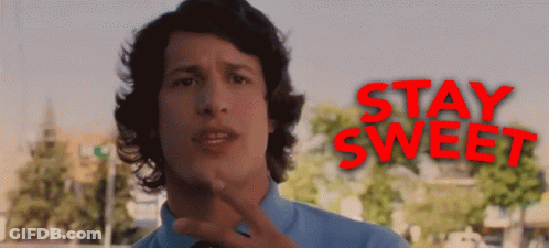 A Man In A Blue Shirt And Tie Stands In Front Of A Sign That Says Stay Sweet GIF