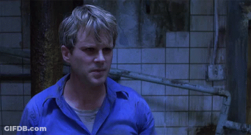 A Man In A Blue Shirt Asks " What Does That Mean " GIF