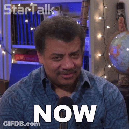 A Man In A Blue Shirt Has The Word Now On His Chest GIF