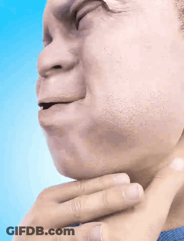A Man In A Blue Shirt Holds His Hand To His Throat GIF