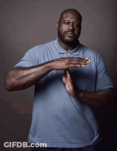 A Man In A Blue Shirt Holds His Hands Together In Front Of His Chest GIF