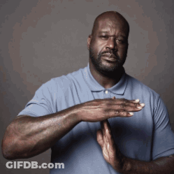 A Man In A Blue Shirt Holds His Hands Together In Front Of His Chest GIF
