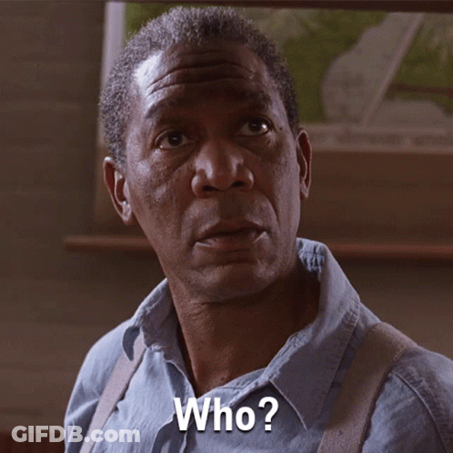A Man In A Blue Shirt Is Asking The Question Who GIF