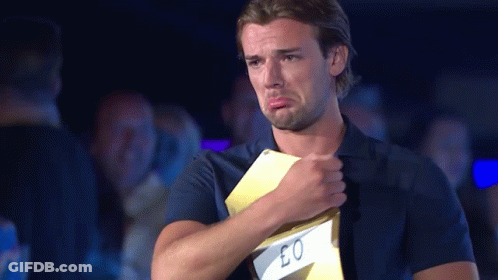 A Man In A Blue Shirt Is Crying While Holding A Card That Says Eo GIF
