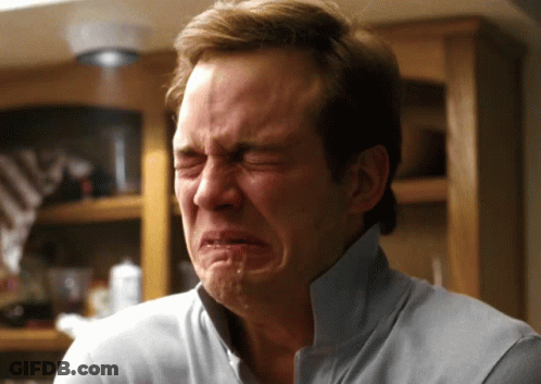 A Man In A Blue Shirt Is Crying With Tears Coming Out Of His Eyes GIF