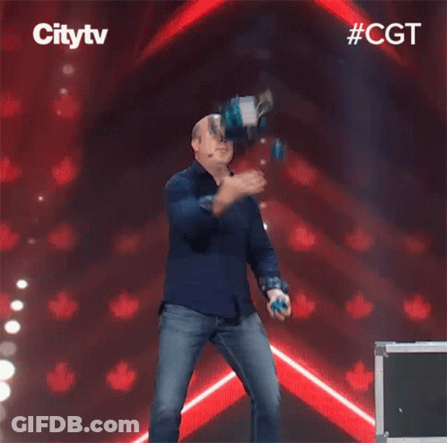 A Man In A Blue Shirt Is Dancing On A Stage In Front Of A Sign That Says City TV GIF