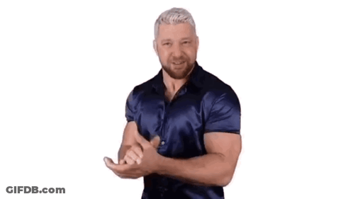 A Man In A Blue Shirt Is Dancing With His Hands Outstretched . GIF