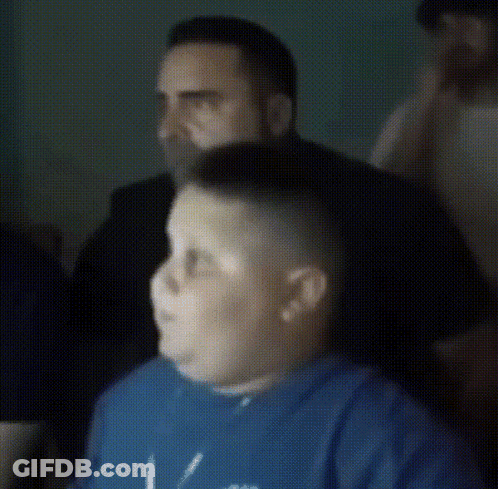 A Man In A Blue Shirt Is Getting His Hair Shaved By Another Man GIF