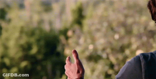 A Man In A Blue Shirt Is Giving A Thumbs Up Sign GIF
