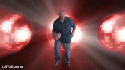 A Man In A Blue Shirt Is Holding A Basketball In Front Of A Red Background GIF