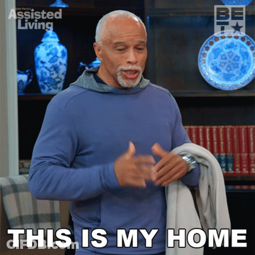 A Man In A Blue Shirt Is Holding A Blanket And Says This Is My Home GIF