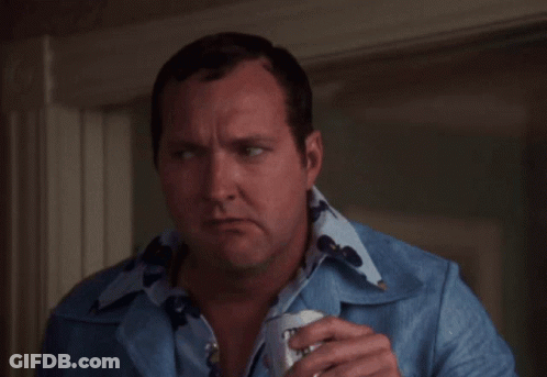A Man In A Blue Shirt Is Holding A Can Of Bud Light Beer GIF