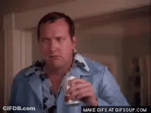 A Man In A Blue Shirt Is Holding A Can Of Soda GIF