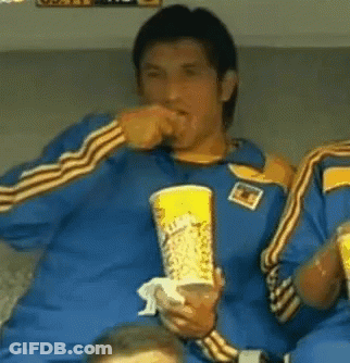 A Man In A Blue Shirt Is Holding A Cup Of Coca Cola GIF