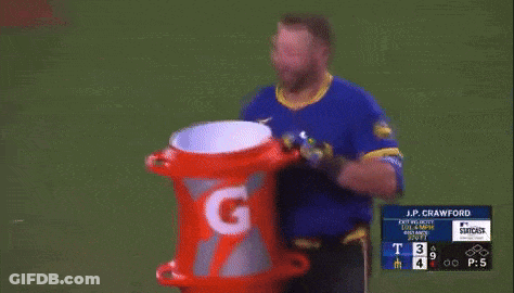 A Man In A Blue Shirt Is Holding A Gatorade Can GIF