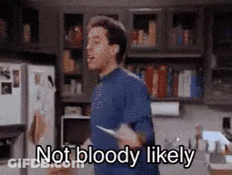 A Man In A Blue Shirt Is Holding A Knife In A Kitchen And Says `` Not Bloody Likely '' . GIF