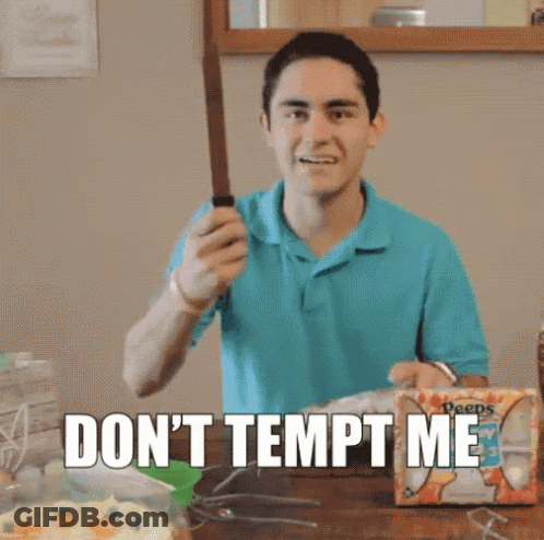 A Man In A Blue Shirt Is Holding A Knife In Front Of A Box That Says Deeps GIF