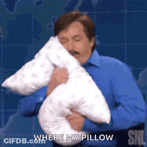 A Man In A Blue Shirt Is Holding A Pillow In His Hands And Saying `` Where My Pillow '' . GIF