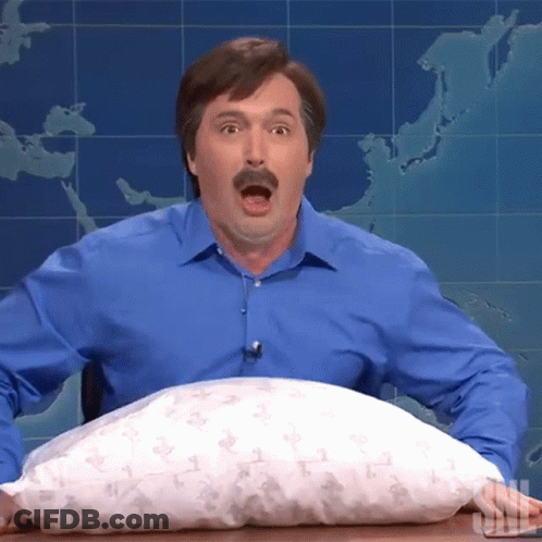 A Man In A Blue Shirt Is Holding A Pillow That Says Snl GIF
