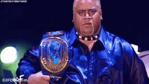 A Man In A Blue Shirt Is Holding A World Heavyweight Championship . GIF