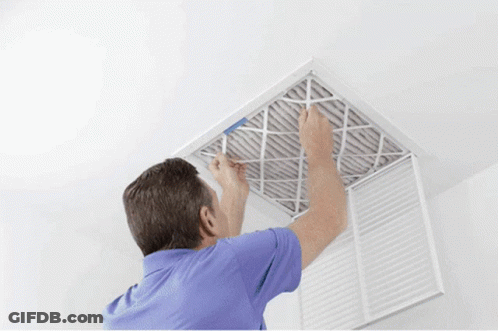 A Man In A Blue Shirt Is Installing A Filter GIF