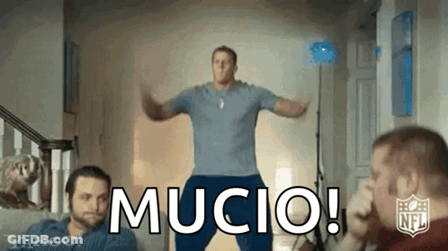 A Man In A Blue Shirt Is Jumping In The Air With The Word Mucio In Front Of Him . GIF