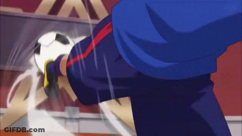 A Man In A Blue Shirt Is Kicking A White Ball GIF