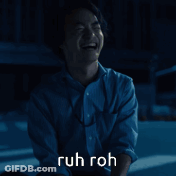 A Man In A Blue Shirt Is Laughing With The Words Ruh Roh Written Above Him GIF