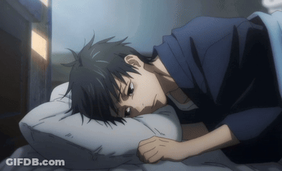 A Man In A Blue Shirt Is Laying On A Bed With His Head On A White Pillow GIF