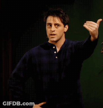 A Man In A Blue Shirt Is Making A Funny Face And Pointing At Something GIF
