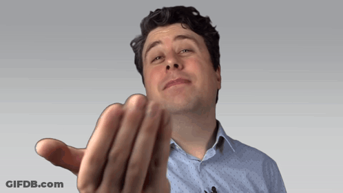 A Man In A Blue Shirt Is Making A Funny Face With His Hand GIF