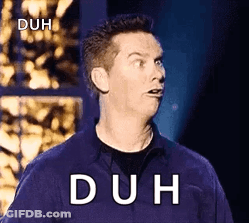 A Man In A Blue Shirt Is Making A Funny Face With The Word Duh Written On The Screen Behind Him . GIF