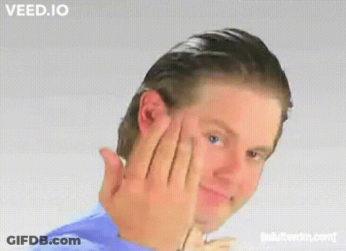 A Man In A Blue Shirt Is Making A Funny Face With Veed.io Written On The Bottom GIF