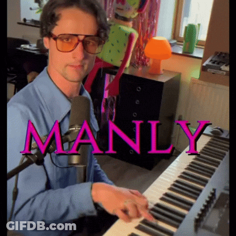 A Man In A Blue Shirt Is Playing A Keyboard With The Word Manly In Pink GIF
