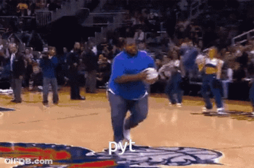 A Man In A Blue Shirt Is Running On A Basketball Court With The Word " Pyt " On The Bottom GIF