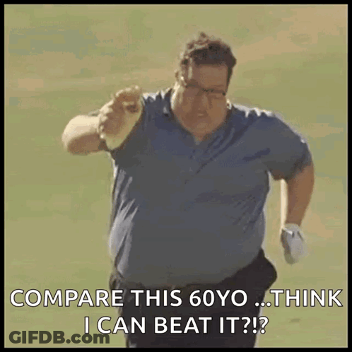 A Man In A Blue Shirt Is Running On A Golf Course And Pointing At Something . GIF