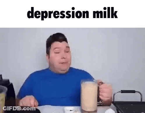 A Man In A Blue Shirt Is Sitting At A Table Drinking A Glass Of Depression Milk . GIF