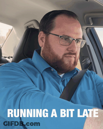 A Man In A Blue Shirt Is Sitting In A Car With The Words Running A Bit Late Behind Him GIF