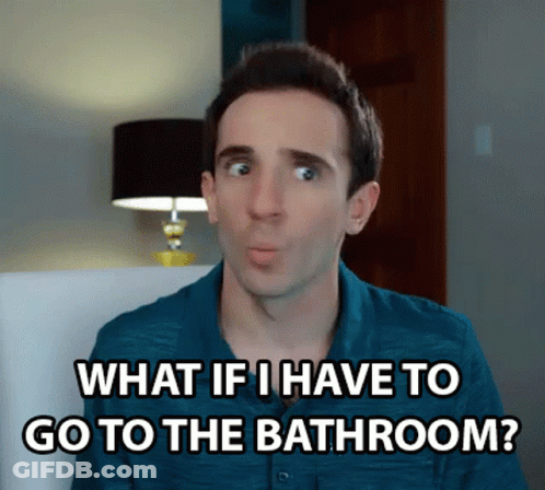 A Man In A Blue Shirt Is Sitting In A Chair And Saying What If I Have To Go To The Bathroom ? GIF