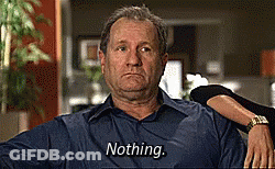A Man In A Blue Shirt Is Sitting In A Chair And Says Nothing GIF